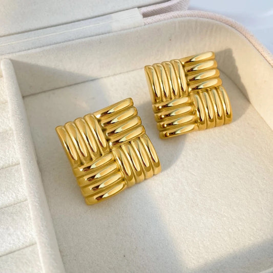 A pair of gold-plated square stud earrings with a woven or braided pattern.