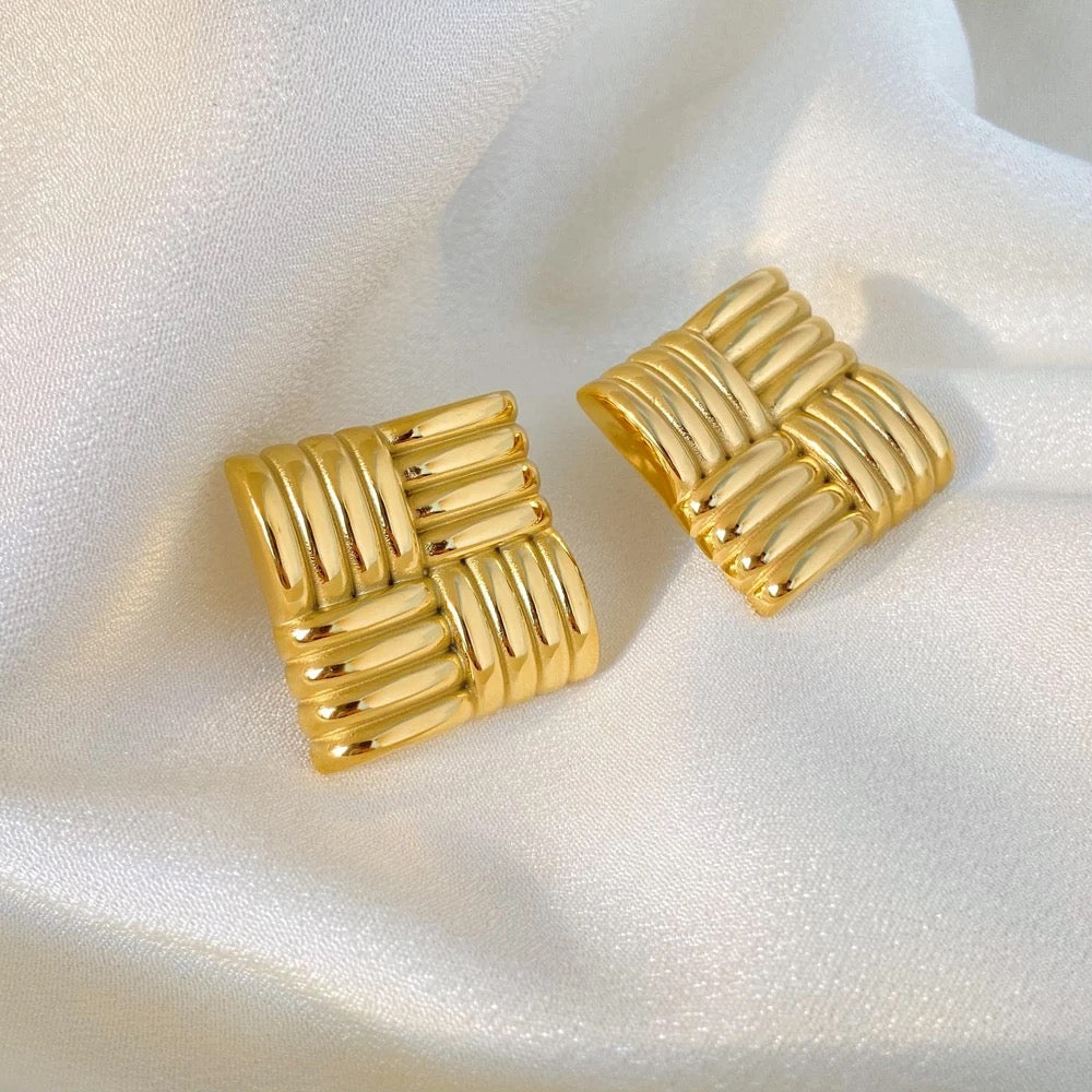 A pair of gold-plated square stud earrings with a woven or braided pattern.