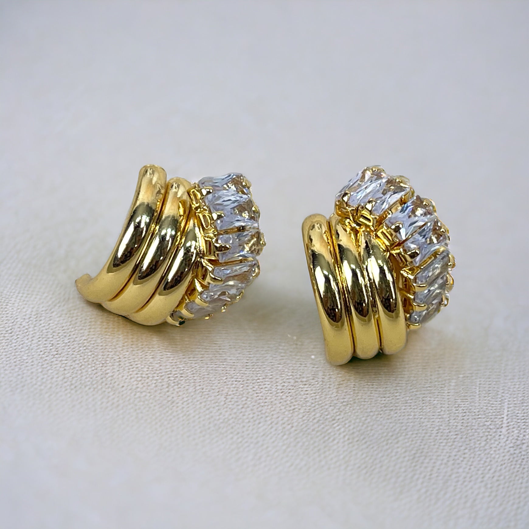 Gold vintage knot earrings with sparkling cubic zirconia stones. The earrings feature a unique knot design with multiple curved gold bands.