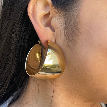 Large, round, gold hoop earrings with a polished finish.